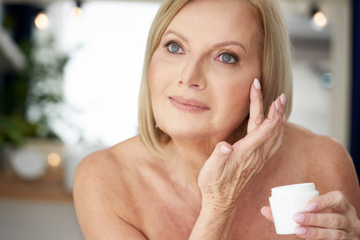 Senior Woman Using Anti-Wrinkling Cream